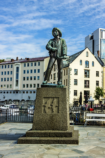 Alesund, Norway - May 23, 2022: Monument to fisherman in seafront of Alesund town