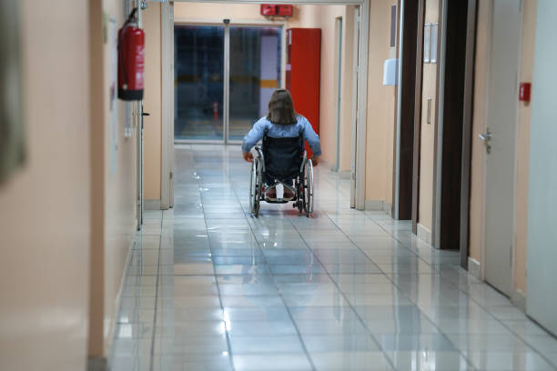 istock Woman in wheelchair inside building 1463067980