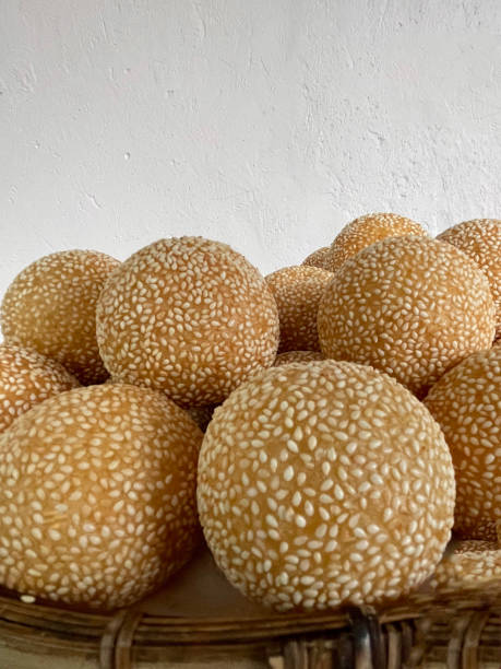istock Khanom Khai Hong is a round bread sprinkled with sesame seeds placed in a basket. 1463068988