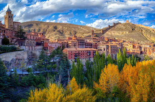 Autumn view of Albarracin with its walls and its cathedral in the foreground.