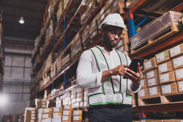 istock Black male staff using digital barcode scanner working checking stock in logistic warehouse 1463069587