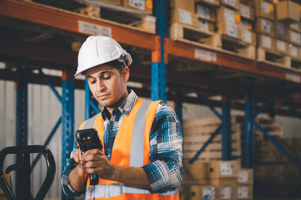 istock Male staff using digital barcode scanner working checking stock in logistic warehouse 1463069627