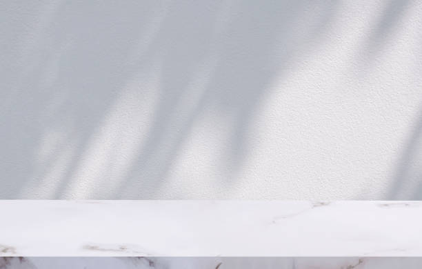 istock Empty White Marble table with branch shadow on surface of Concrete Wall background for Product Display Presentation 1463075869