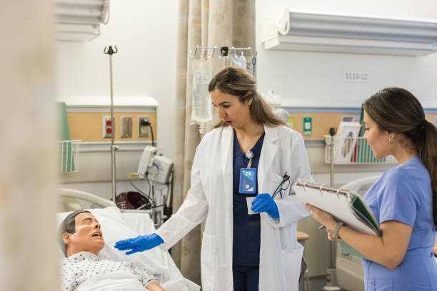 istock Medical school professor uses mannequin to teach intern 1463083524