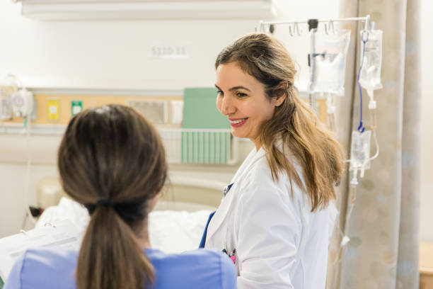 istock Hospital instructor smiles at her trainee as she answers a question 1463083842