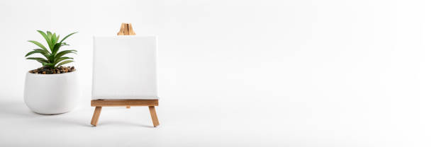 istock White square canvas on wood easel, mockup and ad art banner with copy space 1463085665