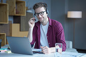 Friendly german guy call center agent consulting client online