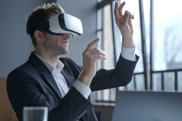 istock Excited man office worker wearing vr goggles touching objects with hands in digital world 1463088930
