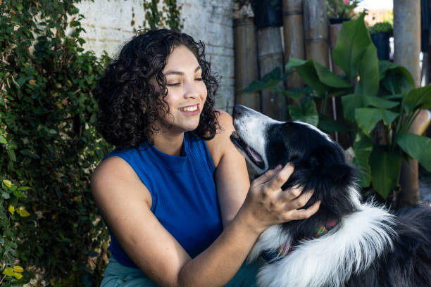 istock Latin woman petting dog 1463090718