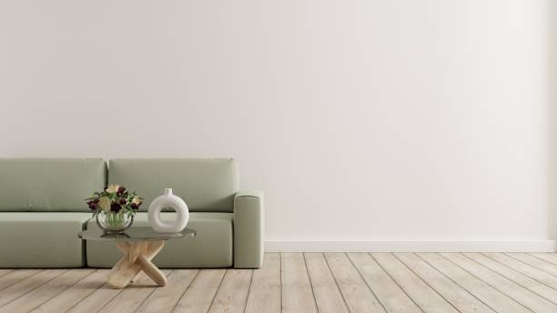 istock Empty living room with green sofa and table on empty white wall background. 1463091179