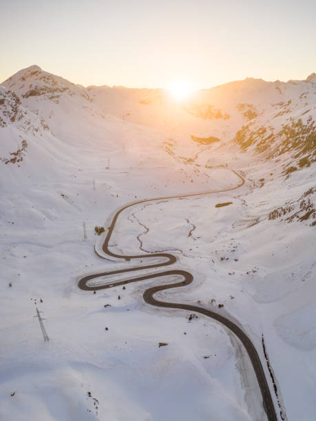 istock Snake shaped pass road in winter during sunset 1463095294