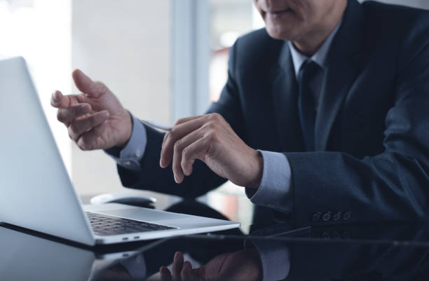 istock Asian businessman making video conference, using online meeting app via laptop computer at office 1463097794