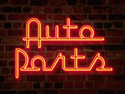 Simulated neon sign in funky retro American 1950s script says Auto Parts. This image is also available on a plain black background.