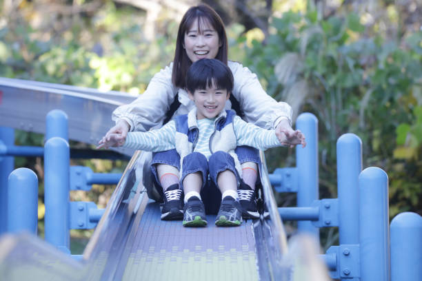 istock Parents and children playing on the slide 1463099813