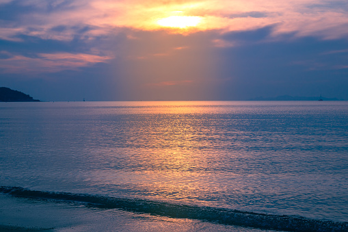 A beautiful sunset with a luminous path in the sea. A seaside celestial landscape.