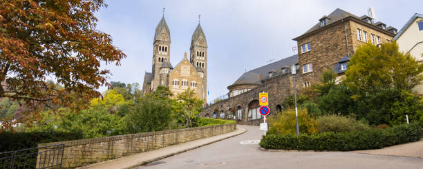 Clervaux, Luxembourg - October 3, 2022: Cityscape with roman catolic church Saints-Come-Et-Damien of  Clervaux in Luxembourg