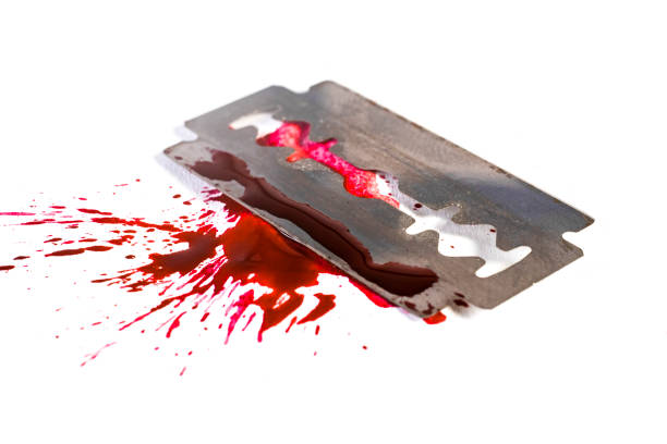 istock Razor blade wit blood splash and blood drops, isolated on white 1463112548