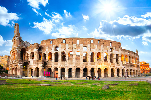 A full wide angle view of the rear of the Roman Colosseum on a bright sunny day.