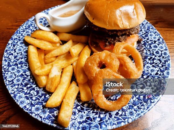 Traditional Hamburger With French Fries Potato Chips Onion Rings At Glasgow Scotland England Uk Stock Photo - Download Image Now