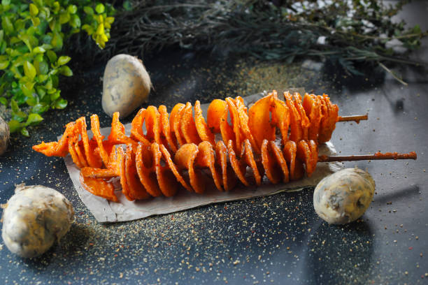 Fried swirls of tornado potato on skewer