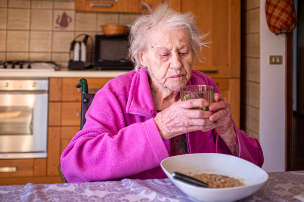 istock Old lady in a wheelchair eating alone 1463123626