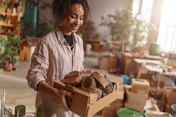 istock Smiling Woman working in home decor studio with elements of interior decorations. Blurred background 1463124815