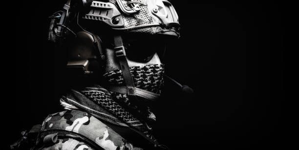 istock Modern army special forces equipped soldier, anti terrorist squad fighter, elite mercenary in helmet, studio portrait in darkness. Close up, half length 1463125002