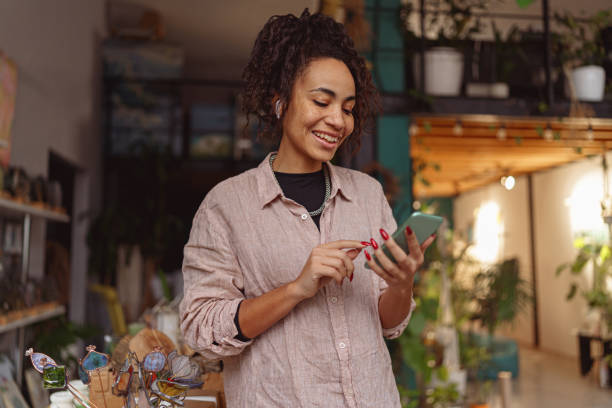 istock Woman floristic studio owner is using phone during working day 1463125036