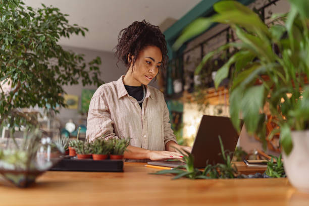 istock Successful female florist working online from own floral studio and check customers order 1463125737