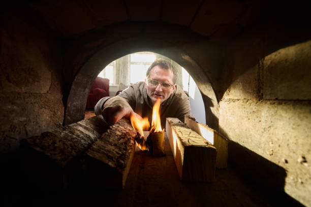istock Villager fired up wood burning stove using birch bark for kindling. 1463126281