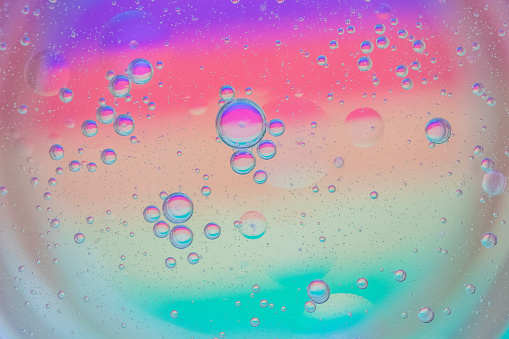 bubbles and oil make for a graphical representation of nature and industry metaphors.  macro extreme close up detail.