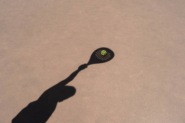 shadow of padel racket over ball - the paddle racket imagens e fotografias de stock