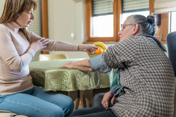 istock Helping mom to check her blood pressure level at home 1463132591
