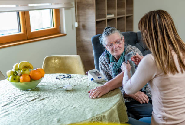 istock Helping mom to check her blood pressure level at home 1463132791