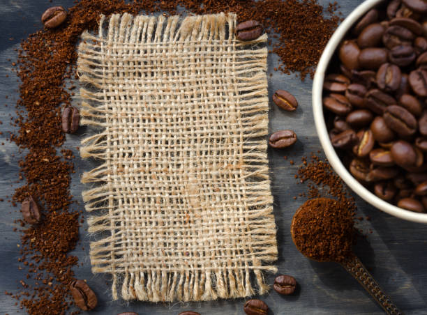istock Coffee cone with ground coffee lie on coffee beans on burlap. 1463136700
