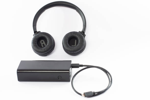 istock Wireless bluetooth headphones on a white background with a power bank. 1463140248