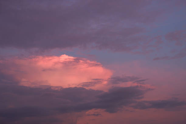 The sky at sunset before bad weather. Low red sunlight illuminates thunderclouds.