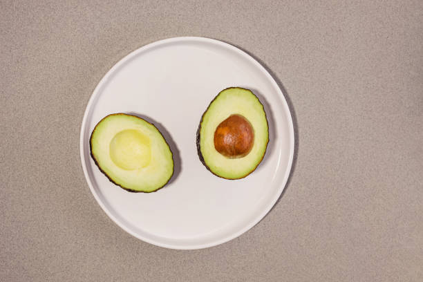 istock Ripe avocado cut in halves on the white plate 1463140431