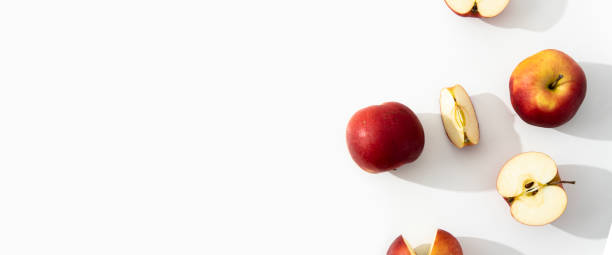 istock Whole, halves and cut apples on a white background. Top view, flat lay. Banner 1463141876