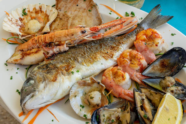 seafood fish platter in valun cres island croatia with tuna fish shrimps and mussels - dinner croatia bildbanksfoton och bilder