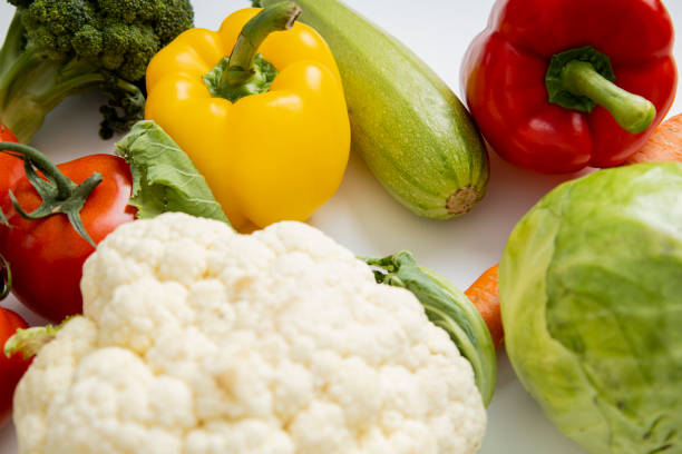 Fresh whole vegetables on a white table. Cooking, diet.