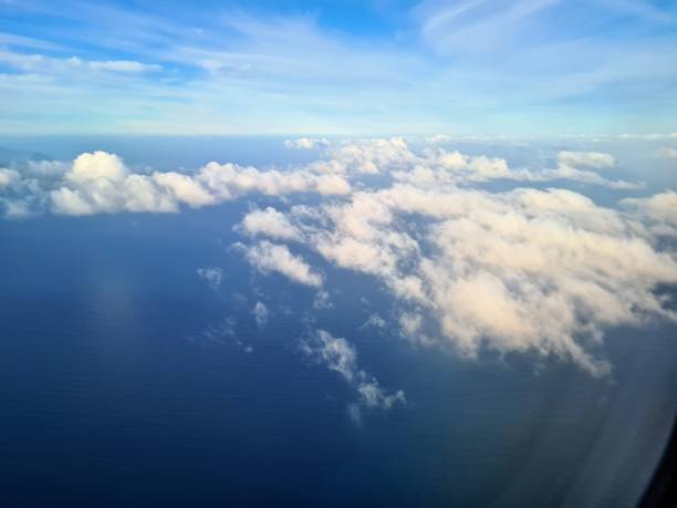 istock clouds seen from an airplane with the sea in the background 1463145238