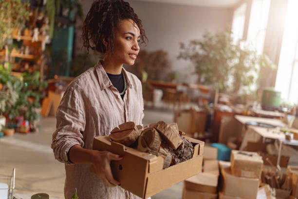 istock Woman holds box with handmade wooden props in a home decor studio. Blurred background 1463145321