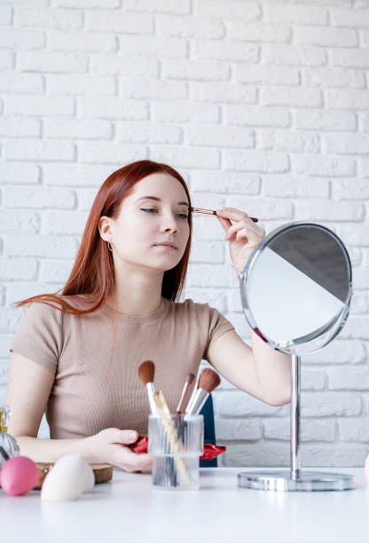 istock young woman making up at home, using eyeshadows 1463149445