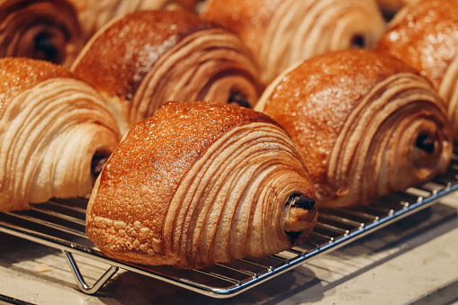 Close-up of fresh and beautiful pain au chocolats in a bakery showcase
