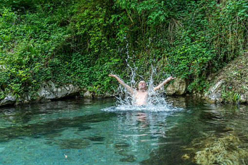 Senior men relaxing and splashing in natural hot spa at Šmarjetske toplice - spa