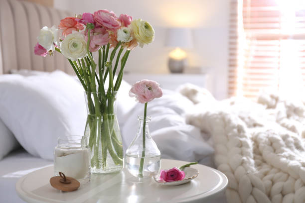 istock Beautiful ranunculus flowers on table in bedroom, space for text 1463164138