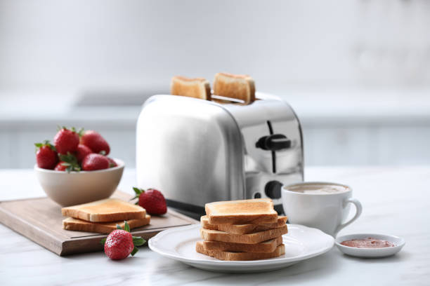 istock Modern toaster and tasty breakfast on white marble table in kitchen 1463164740