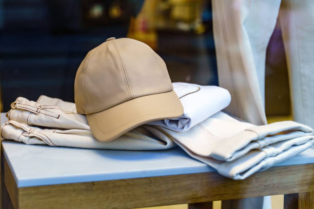 istock Beige leather baseball cap rests on white denim pants 1463177884