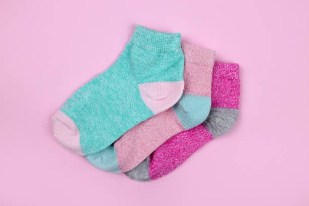 istock Stack of baby socks on pink background 1463178001